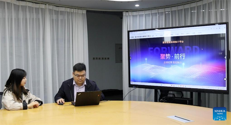 Η Li Huarong (Δ), διευθύντρια λογαριασμών στο Κέντρο Προώθησης της Ψηφιακής Υπηρεσίας BlueFocus (Tianjin), παρουσιάζει την Παγκόσμια Πλατφόρμα Προώθησης Ψηφιακού Εμπορίου της Tianjin σε οθόνη στον Δήμο Tianjin, στη βόρεια Κίνα, στις 15/11/2024. Φωτογραφία: Xinhua