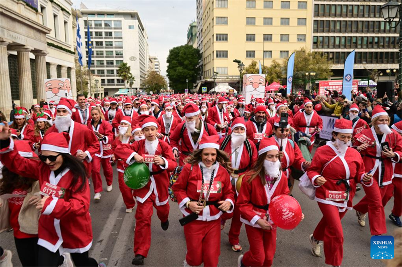Άνθρωποι συμμετέχουν στο Athens Santa Run 2025 στην Αθήνα